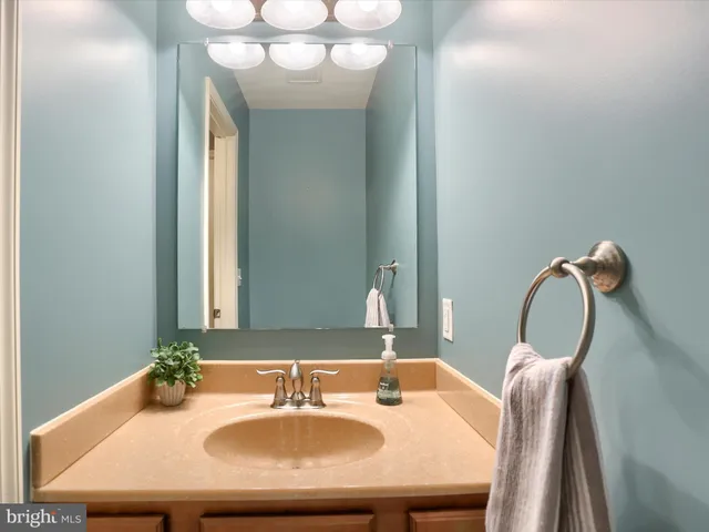 a bathroom with a sink granite and a mirror