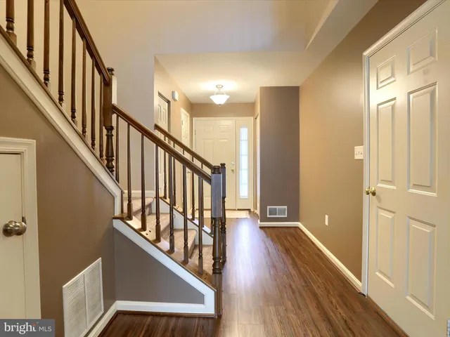 a view of an entryway with wooden floor