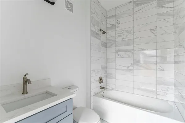 a bathroom with a sink toilet and vanity