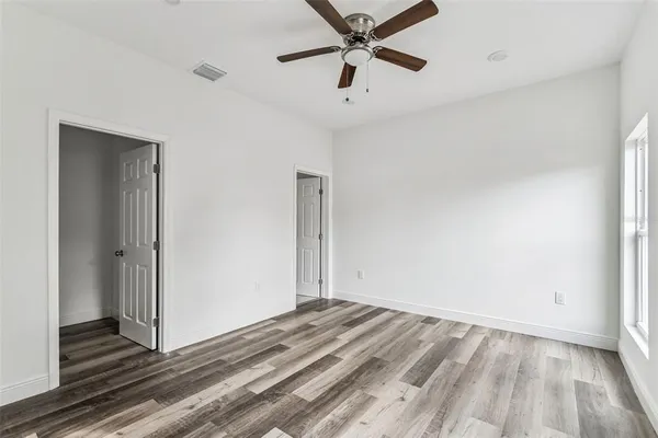 a large kitchen with white cabinets and stainless steel appliances