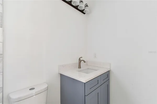 a view of empty room with ceiling fan