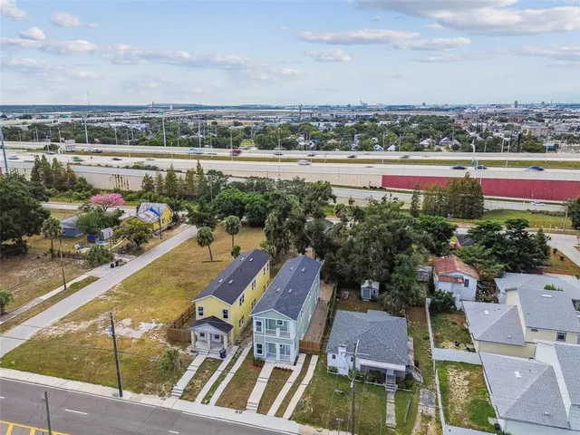 an aerial view of a house with a yard