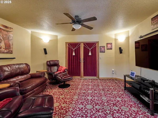 a kitchen with kitchen island granite countertop stainless steel appliances a refrigerator a stove a sink cabinets and a dining table