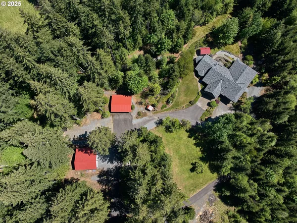an aerial view of a house with a yard and outdoor seating