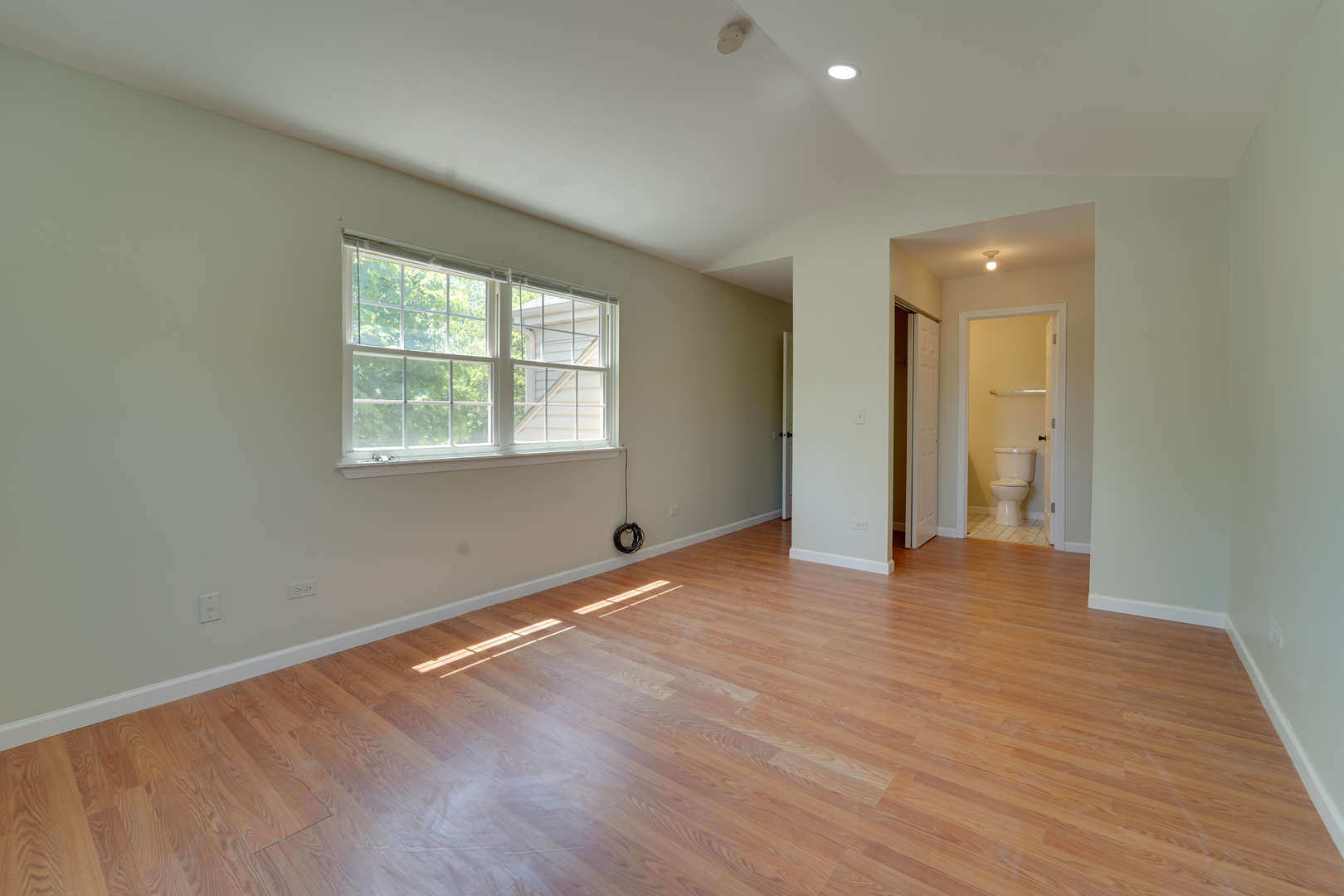 89 King Drive Streamwood, IL 60107 - Photo 11 of 13 an empty room with wooden floor and windows