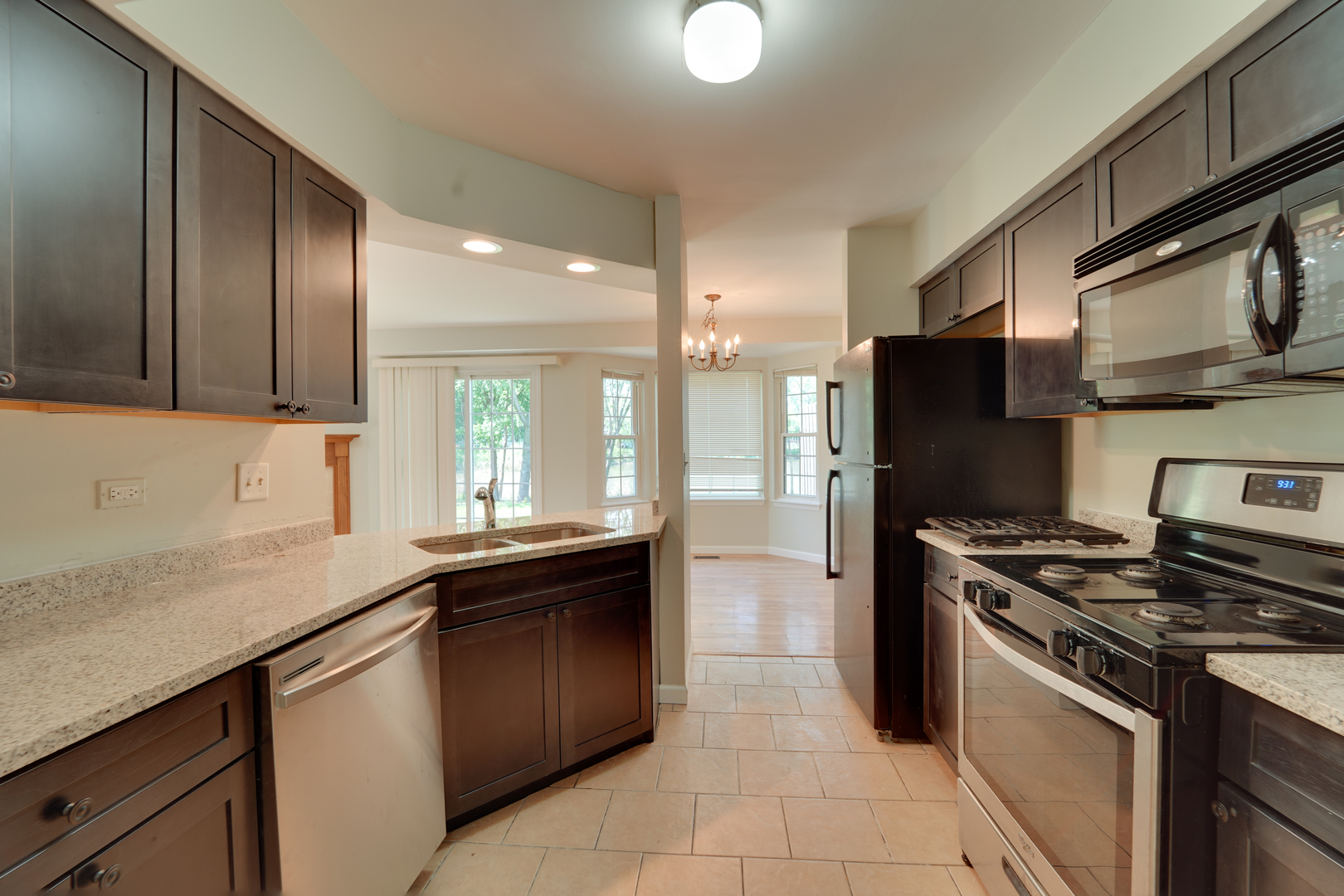 89 King Drive Streamwood, IL 60107 - Photo 12 of 13 a kitchen with stainless steel appliances granite countertop a sink stove and refrigerator