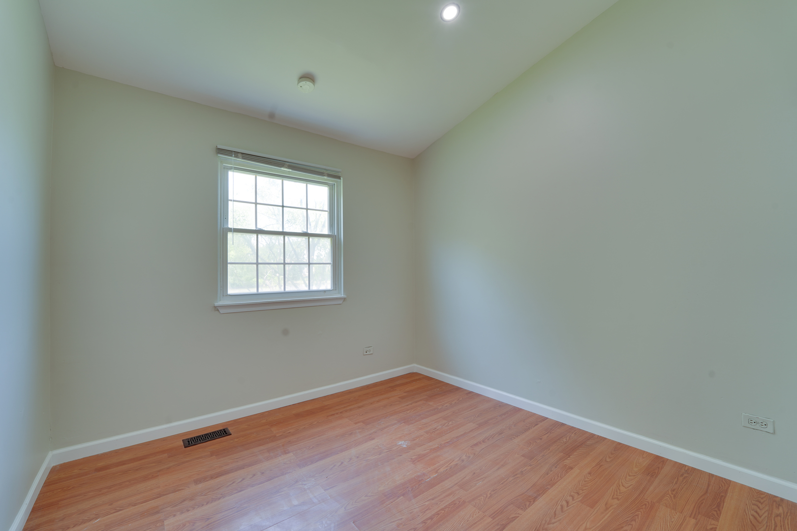 89 King Drive Streamwood, IL 60107 - Photo 8 of 13 an empty room with wooden floor and windows