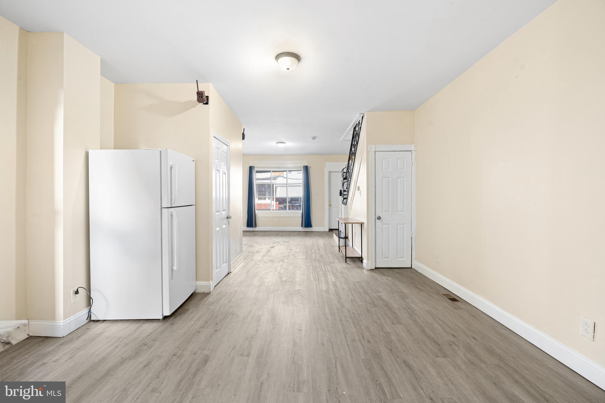 5538 Addison Street Philadelphia, PA 19143 - Photo 11 of 15 a view of a refrigerator in kitchen and wooden floor