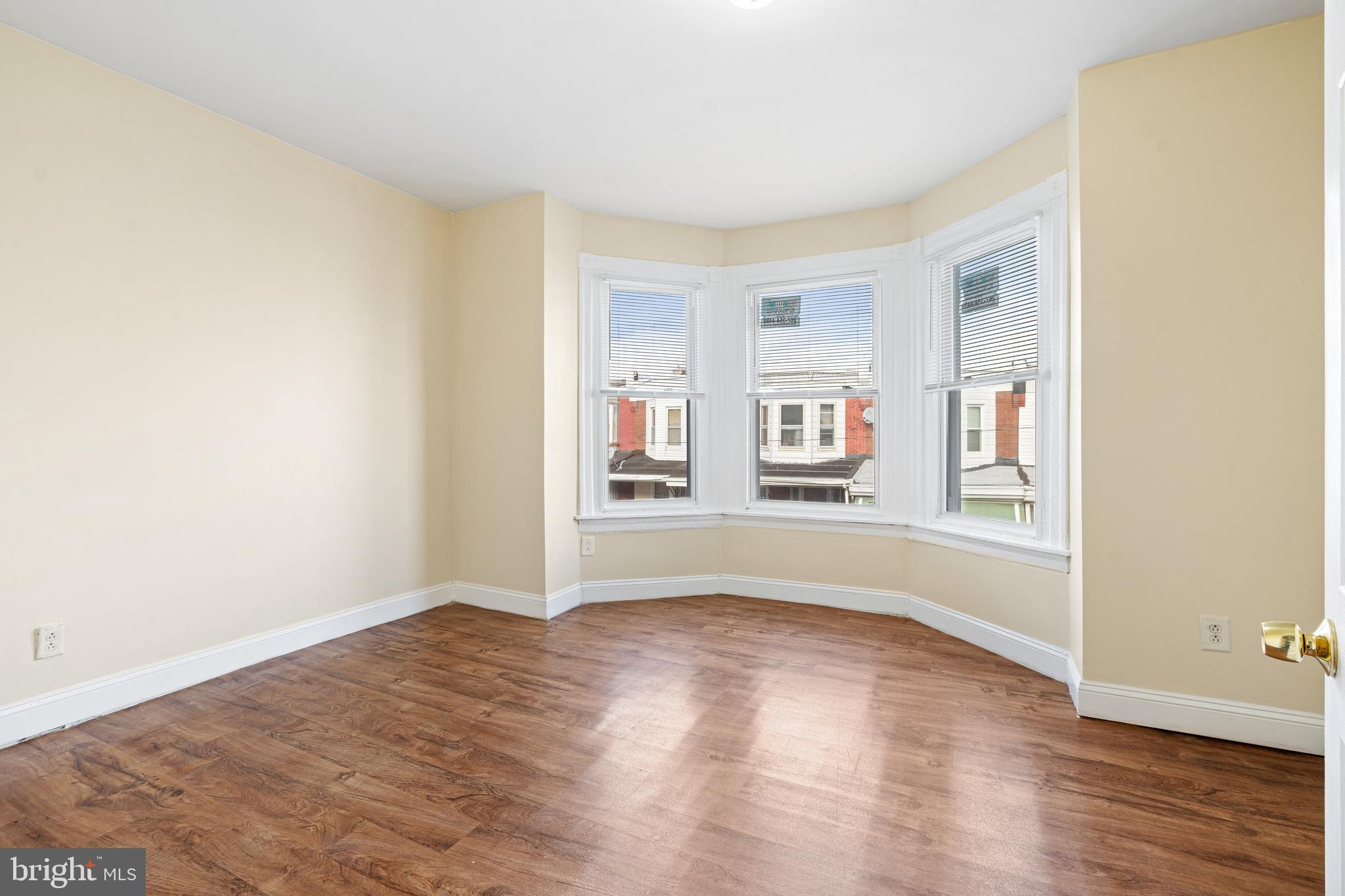 5538 Addison Street Philadelphia, PA 19143 - Photo 2 of 15 an empty room with wooden floor and windows