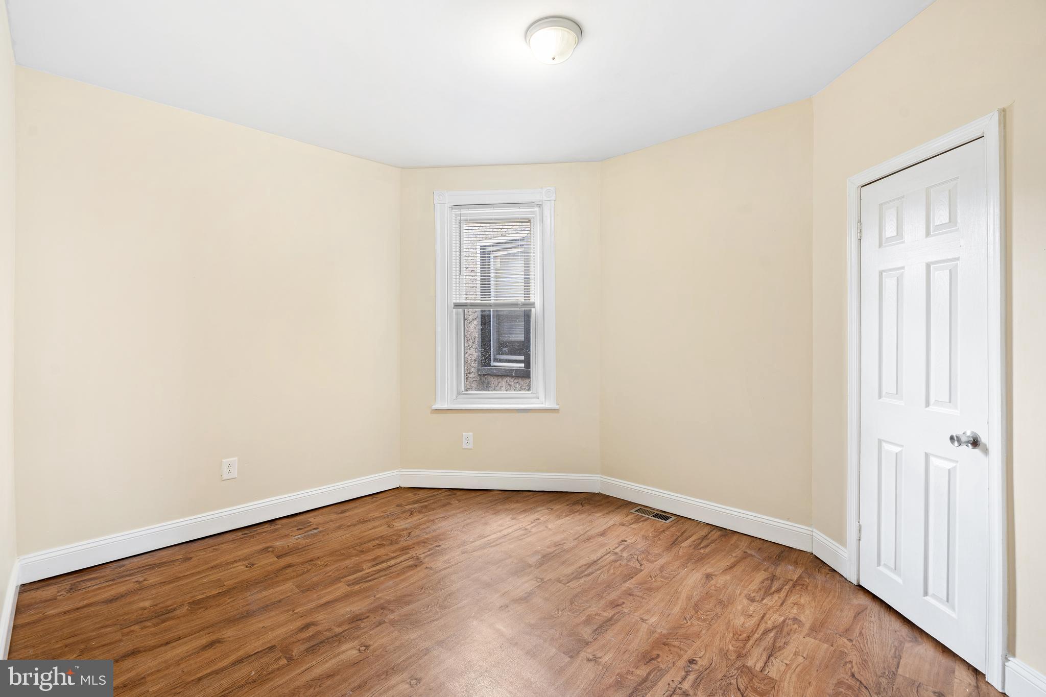 5538 Addison Street Philadelphia, PA 19143 - Photo 4 of 15 an empty room with wooden floor and windows