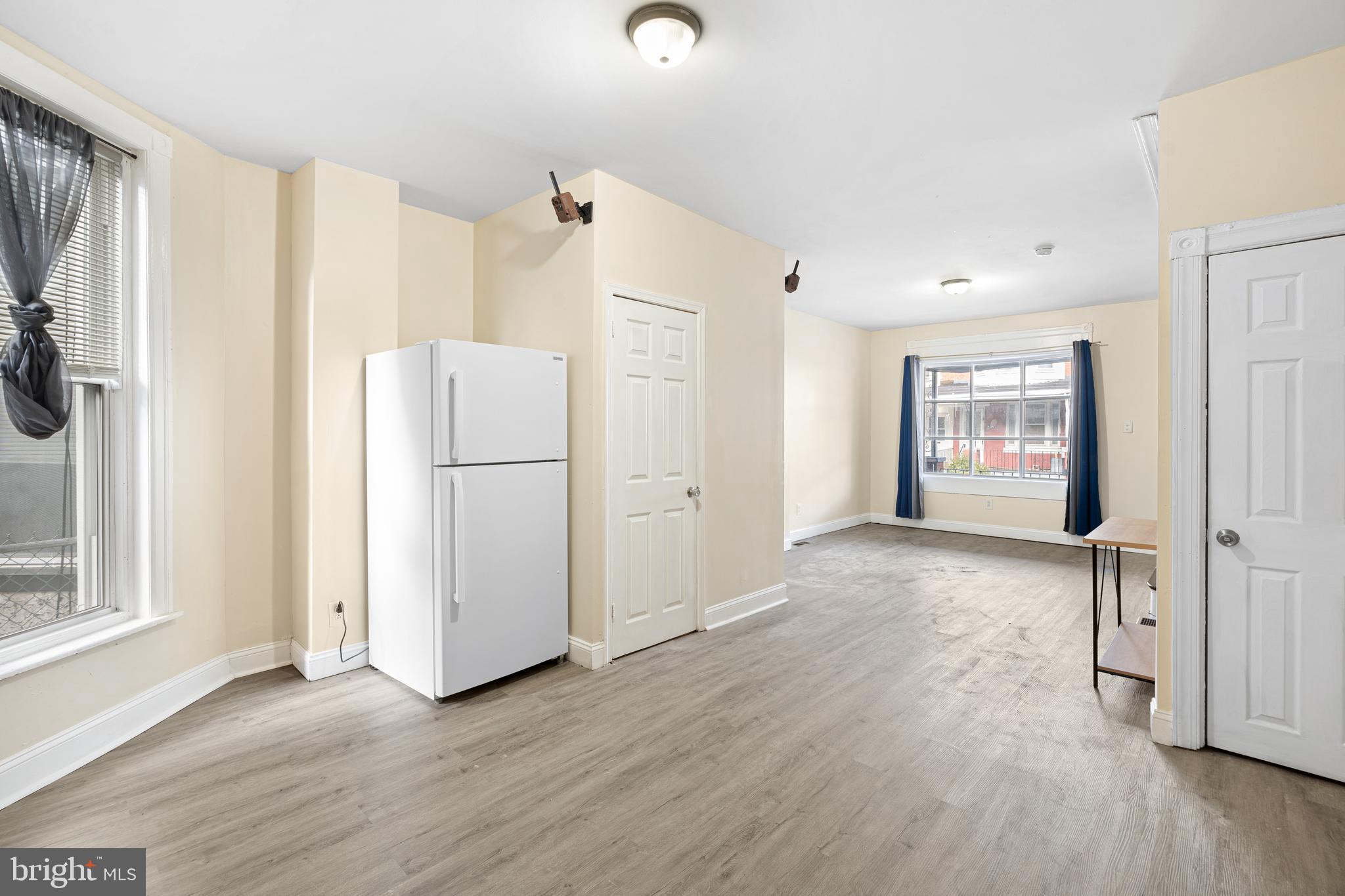 5538 Addison Street Philadelphia, PA 19143 - Photo 9 of 15 a view of a kitchen with wooden floors and refrigerator