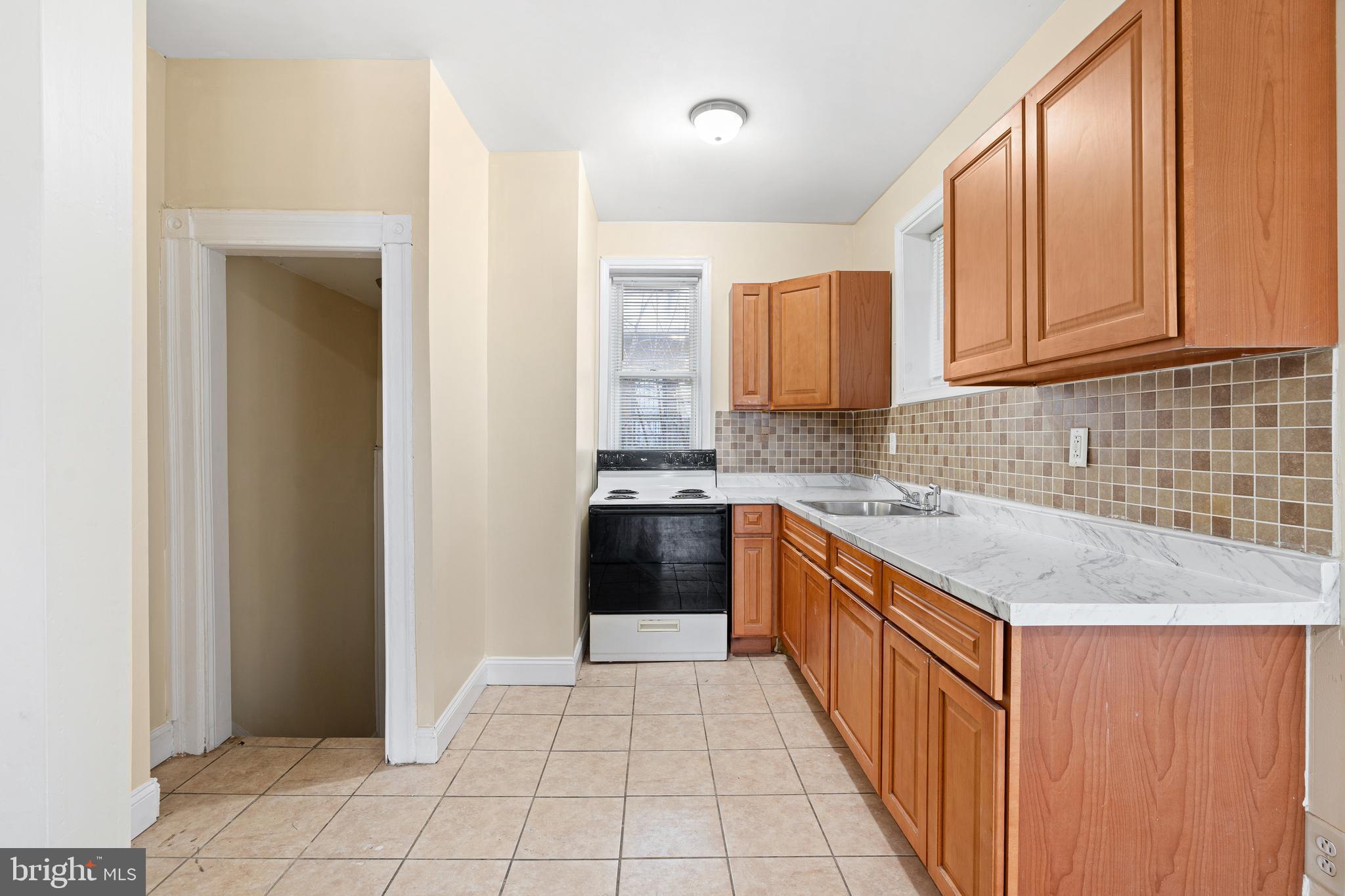 5538 Addison Street Philadelphia, PA 19143 - Photo 10 of 15 a kitchen with stainless steel appliances granite countertop a refrigerator and a sink