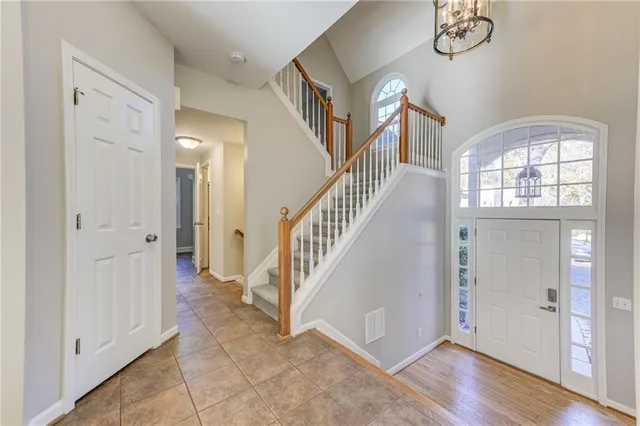 a view of a living room with wooden floor and a ceiling fan