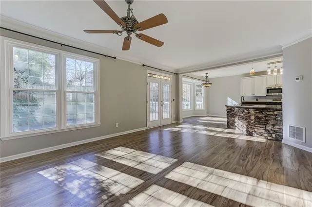 a view of empty room with a fireplace and wooden floor