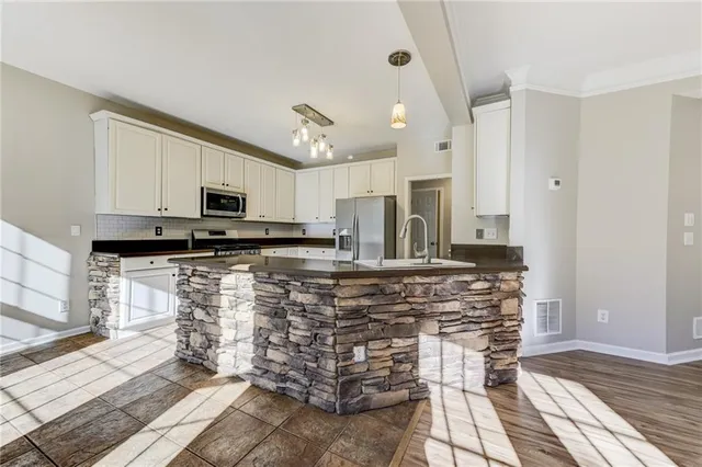 a kitchen with stainless steel appliances and white cabinets