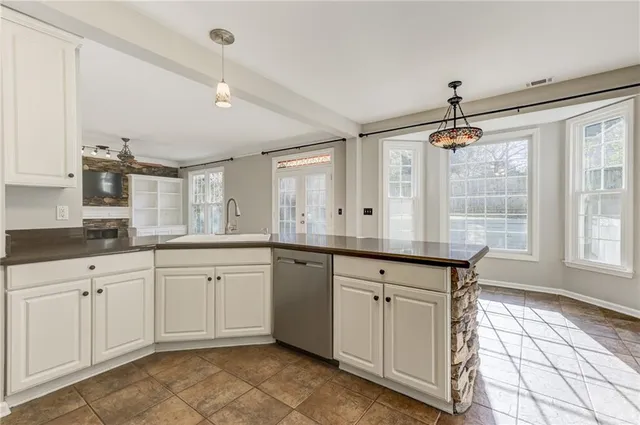 an empty room with a window and a ceiling fan
