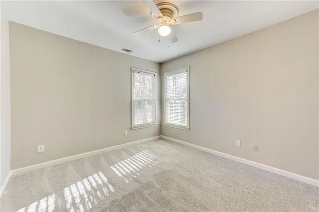 a view of a backyard with wooden fence