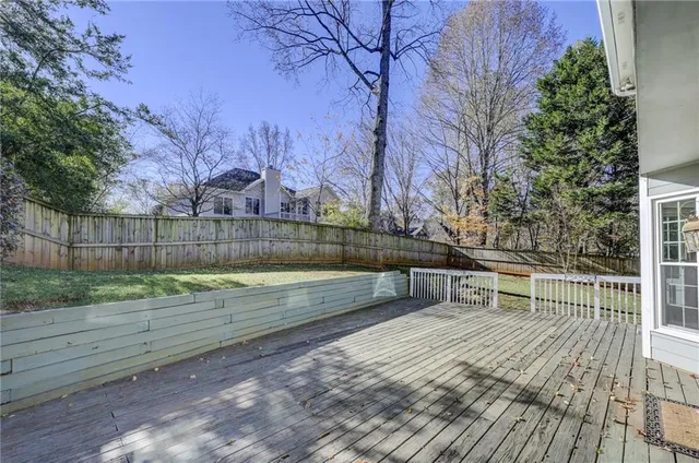 a view of a swimming pool with a patio and fire pit