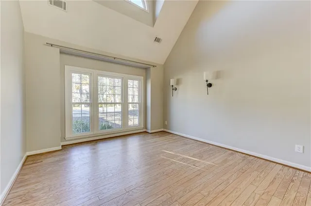 wooden floor in an empty room with a window