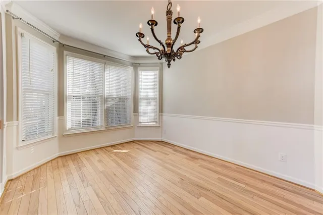 wooden floor with windows and an entryway in a room
