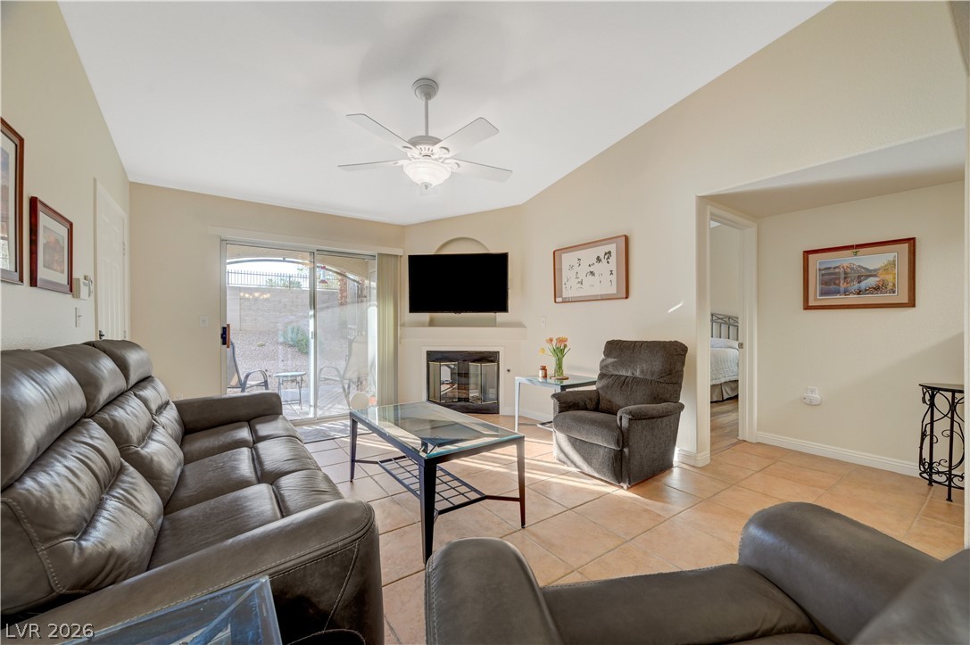 7885 West Flamingo Road, Unit 1071 Las Vegas, NV 89147 - Photo 7 of 28 A comfortable living space offers tiled flooring and a fireplace, ideal for relaxation and entertaining.