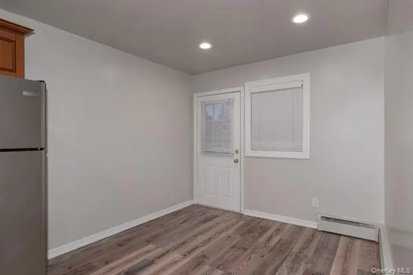 a view of an empty room with wooden floor