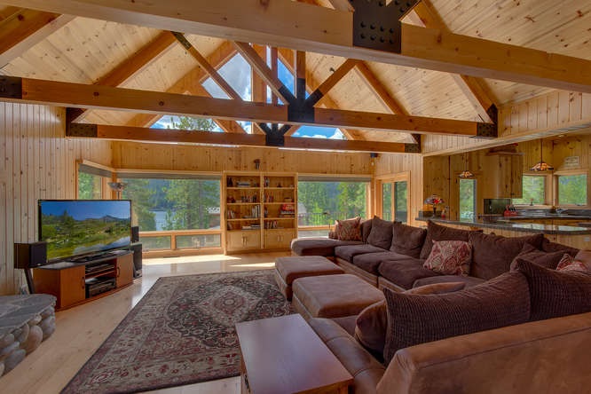 16073 Matt's Mountain Place Truckee, CA 96161 - Photo 3 of 14 a living room with furniture a flat screen tv and a floor to ceiling window