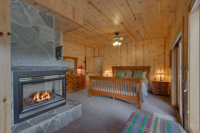 16073 Matt's Mountain Place Truckee, CA 96161 - Photo 10 of 14 a bedroom with furniture and a fireplace