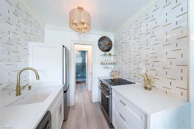 a kitchen with a sink and a stove with a kitchen island