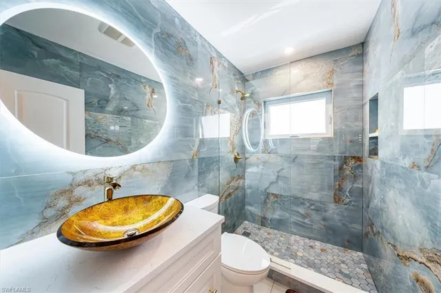 a bathroom with a mirror a sink and a mirror