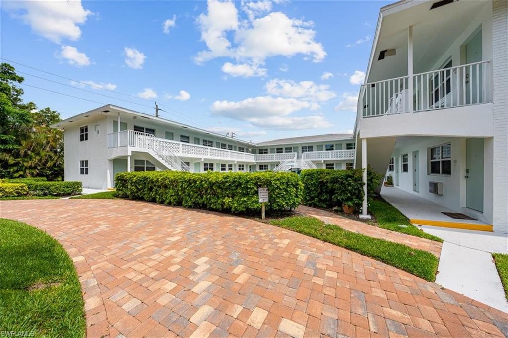 540 4th Avenue South, Unit 13 Naples, FL 34102 - Photo 15 of 19 a front view of a house with a yard