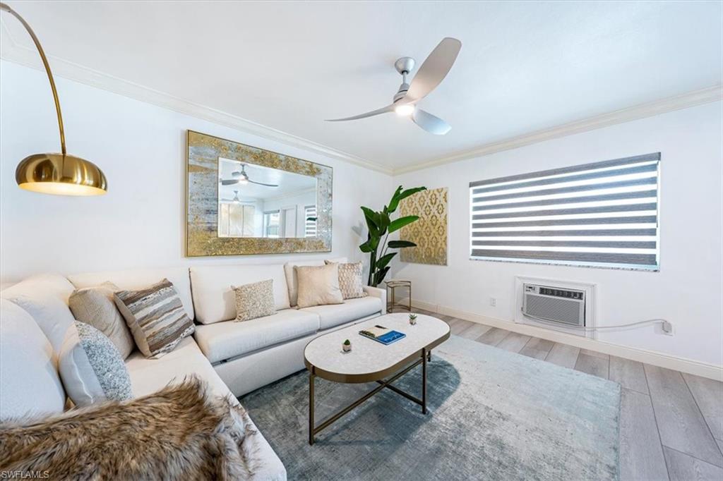 540 4th Avenue South, Unit 13 Naples, FL 34102 - Photo 4 of 19 a living room with furniture and a large window