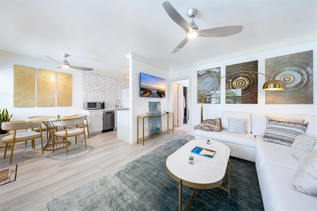 540 4th Avenue South, Unit 13 Naples, FL 34102 - Photo 5 of 19 a living room with furniture and a wooden floor