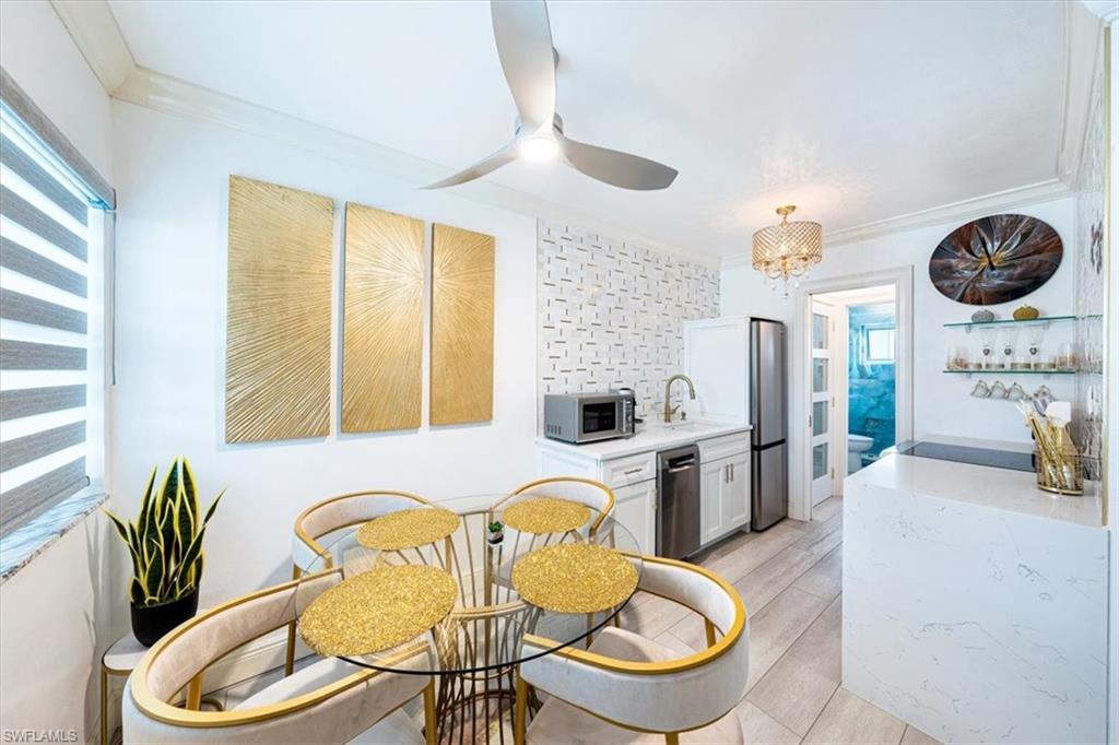 540 4th Avenue South, Unit 13 Naples, FL 34102 - Photo 6 of 19 a living room with furniture and a large window