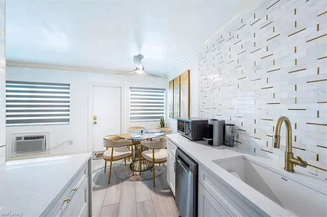 a kitchen with a sink appliances and a counter top space