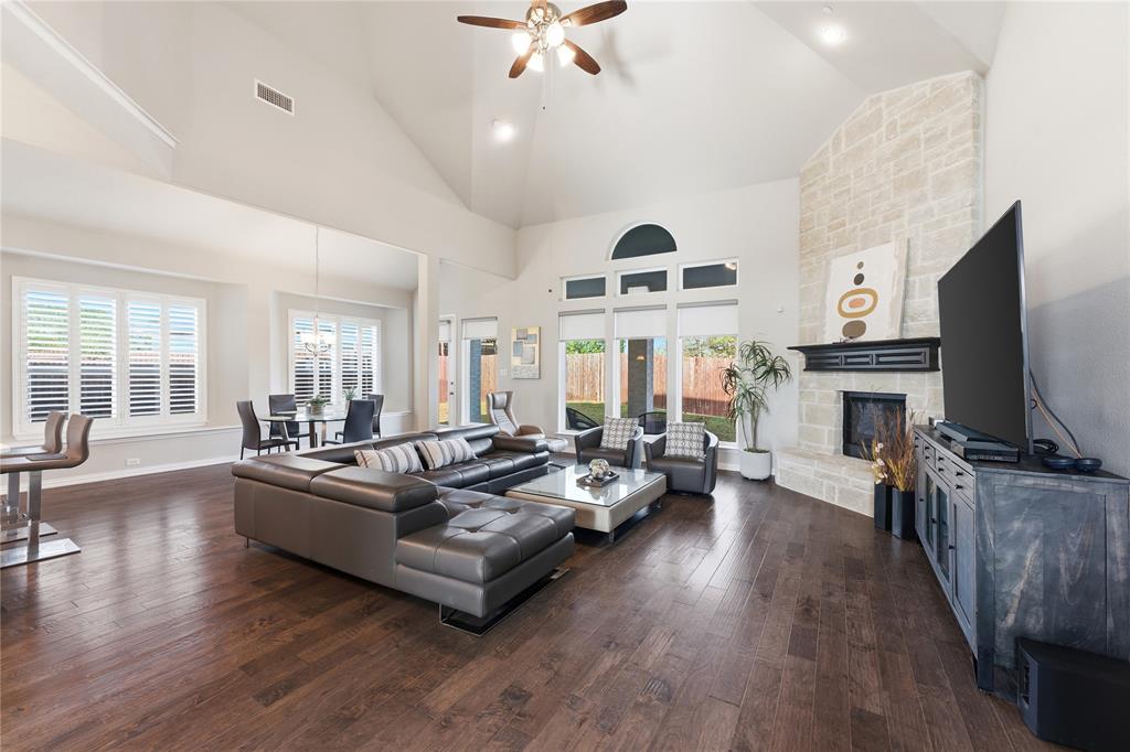 7705 Falcon Ridge Road Denton, TX 76208 - Photo 2 of 40 Living room with dark wood finished floors, ceiling fan, a fireplace, recessed lighting, and lofted ceiling