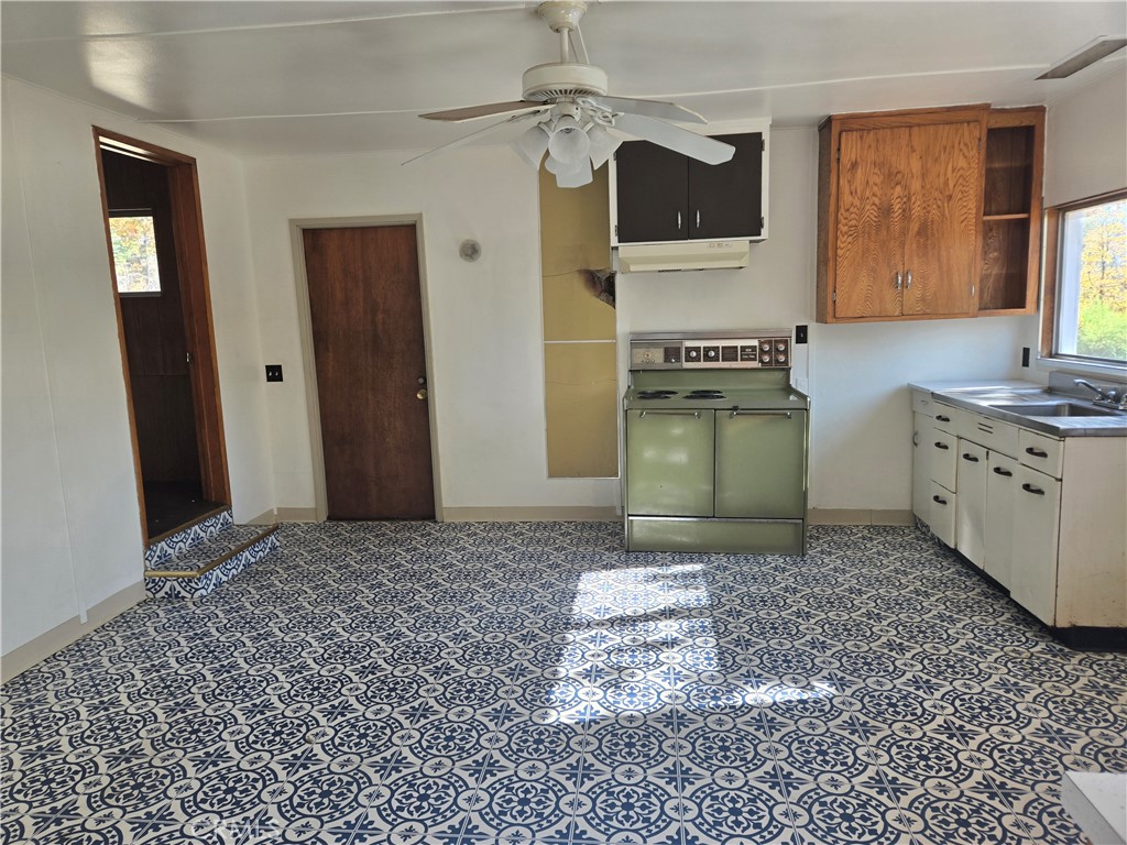 1171 Bald Rock Road Berry Creek, CA 95916 - Photo 6 of 20 a kitchen with stainless steel appliances granite countertop a stove a sink and a refrigerator