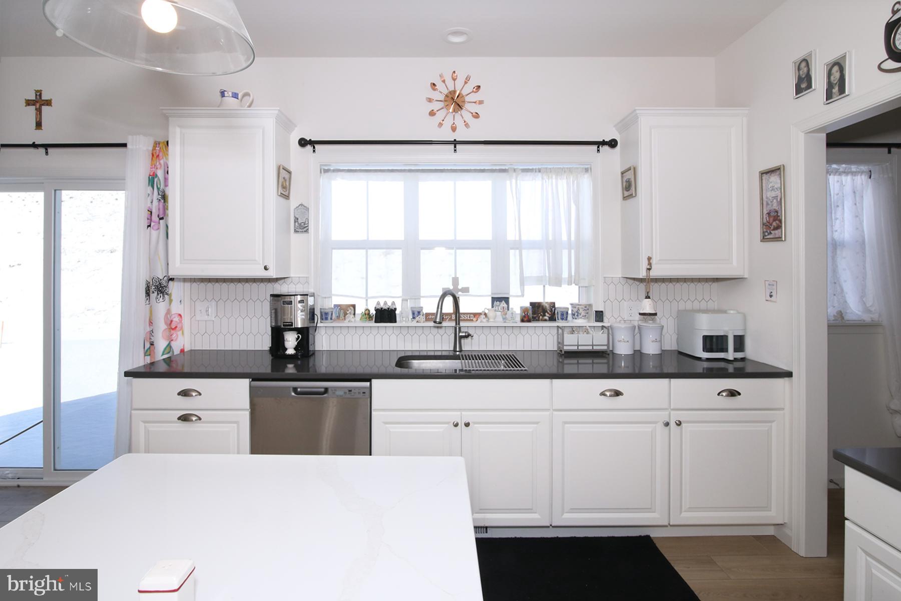 216 Copper Ridge Drive Newmanstown, PA 17073 - Photo 14 of 45 a kitchen with white cabinets and window