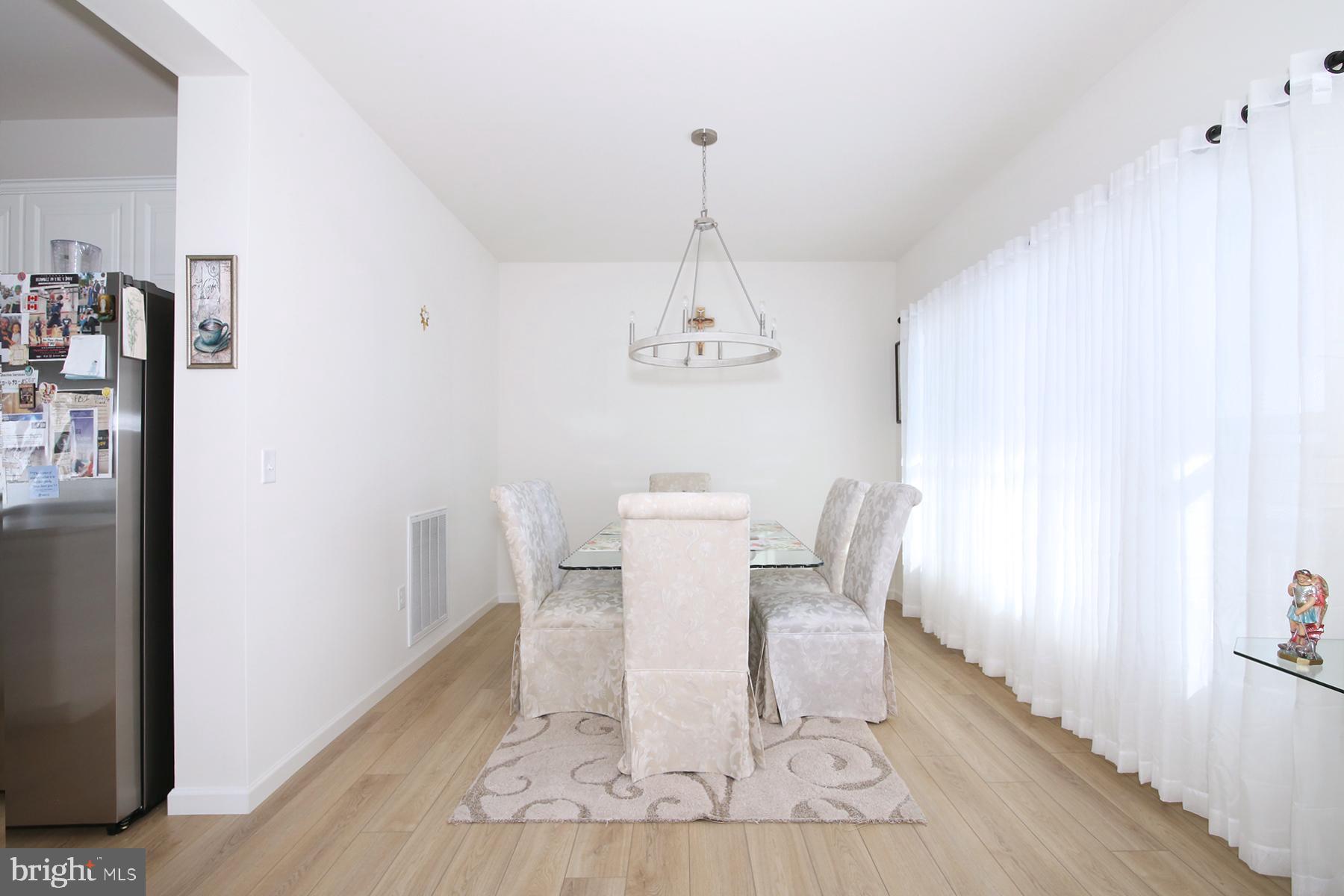 216 Copper Ridge Drive Newmanstown, PA 17073 - Photo 9 of 45 a dining room with wooden floor and a chandelier