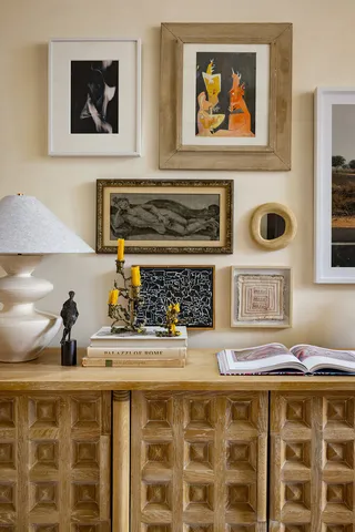 a living room with a stove and a painting on the wall