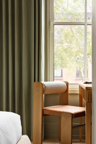 a bathroom with a toilet and a window