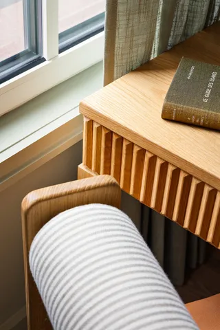 a bed sitting in a bedroom next to a window