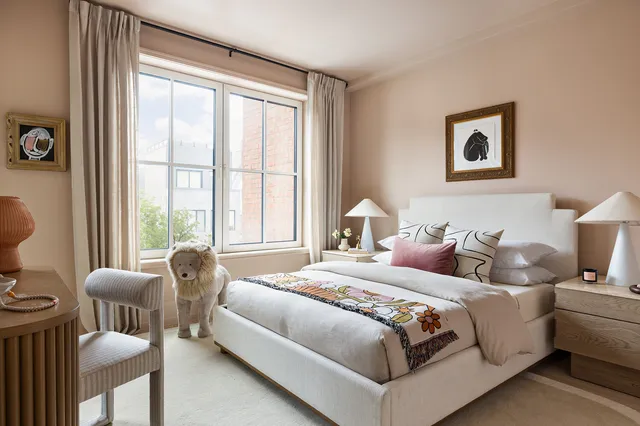 a bedroom with bed and a large window