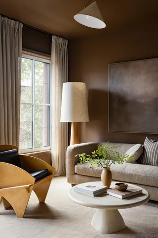 a living room with furniture and a potted plant