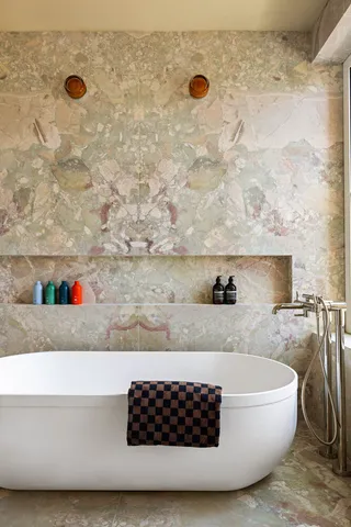 a bathroom with a bathtub and a shower