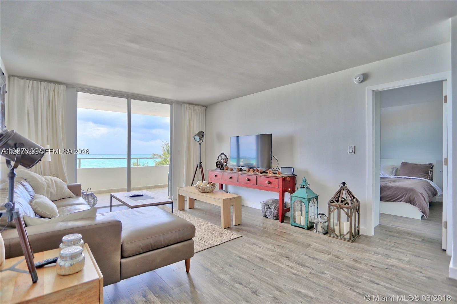 5555 Collins Avenue, Unit 5F Miami Beach, FL 33140 - Photo 2 of 6 a living room with furniture and a large window
