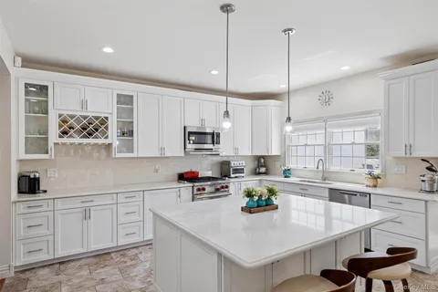 a large white kitchen with a large window