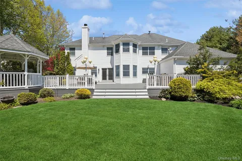 a view of a patio with table and chairs with wooden floor and fence
