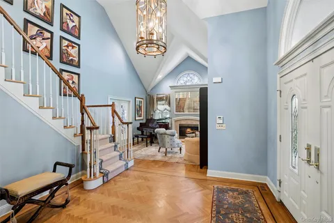a living room with furniture a fireplace and a large window