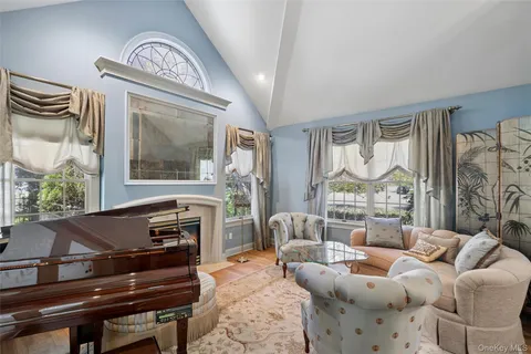 a dining room with furniture a chandelier and window